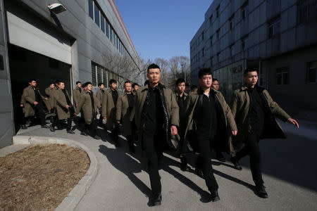 Trainees from Dewei Security walk for a daily training session at a training camp, on the outskirts of Beijing, China March 2, 2017. REUTERS/Jason Lee