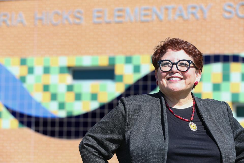 Nancy Vera, president of the Corpus Christi American Federation of Teachers, poses in front of Gloria Hicks Elementary Tuesday, Feb. 20, 2024. Vera said she was helpful in getting the school named after the educational volunteer.