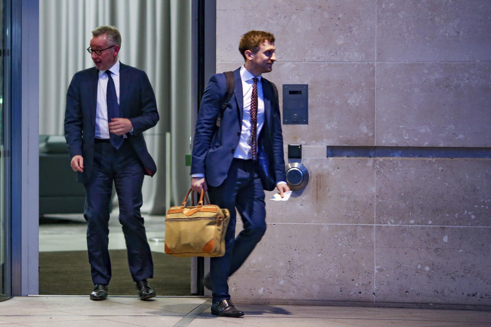 British Conservative party leadership contender Michael Gove, left, leaves BBC House after a TV debate in central London Tuesday, June 18, 2019. (AP Photo/Vudi Xhymshiti)