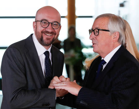 Belgian Prime Minister Charles Michel is welcomed by European Commission President Jean-Claude Juncker at the start of an emergency European Union leaders summit on immigration at the EU Commission headquarters in Brussels, Belgium June 24, 2018. REUTERS/Yves Herman/Pool