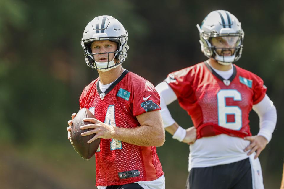 Carolina Panthers quarterback Sam Darnold, left, looks to throw as quarterback Baker Mayfield looks on during the NFL football team's training camp at Wofford College in Spartanburg, S.C., Wednesday, July 27, 2022. (AP Photo/Nell Redmond)