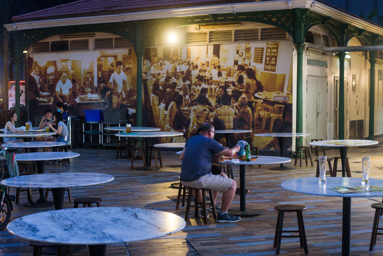 People dining at a food centre in Singapore. 