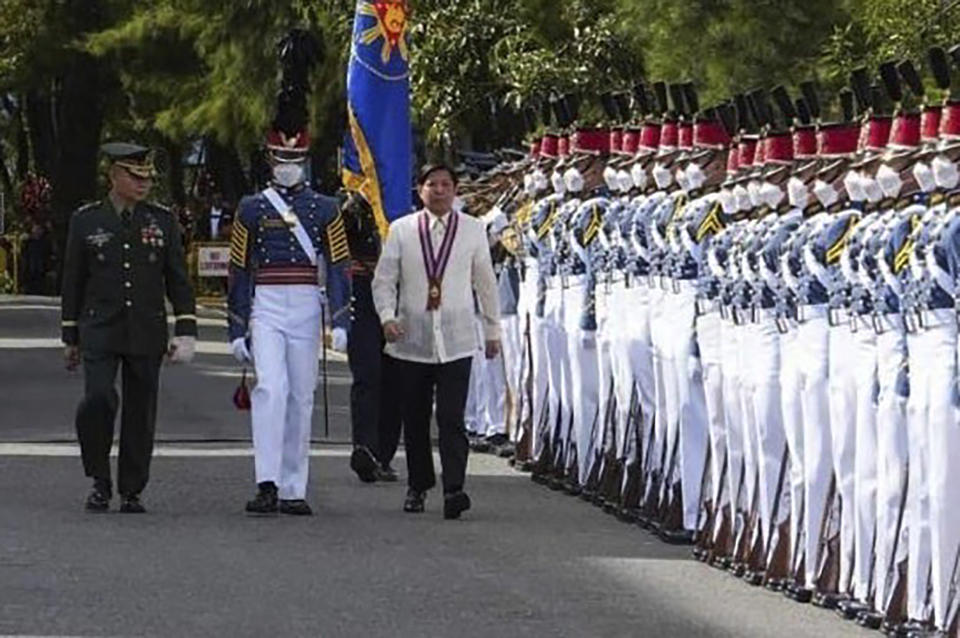 In this photo provided by the Presidential Communications Office, Philippine President Ferdinand Marcos Jr. walks during arrival honors at the Philippine Military Academy in Baguio city, northern Philippines on Saturday Feb. 18, 2023. The Philippine president said Saturday the Chinese coast guard's aiming of a military-grade laser that briefly blinded some crew aboard a Philippine patrol vessel in the disputed South China Sea was not enough for him to invoke a mutual defense treaty with the United States but added he told China that such aggression should stop. (Presidential Communications Office via AP)