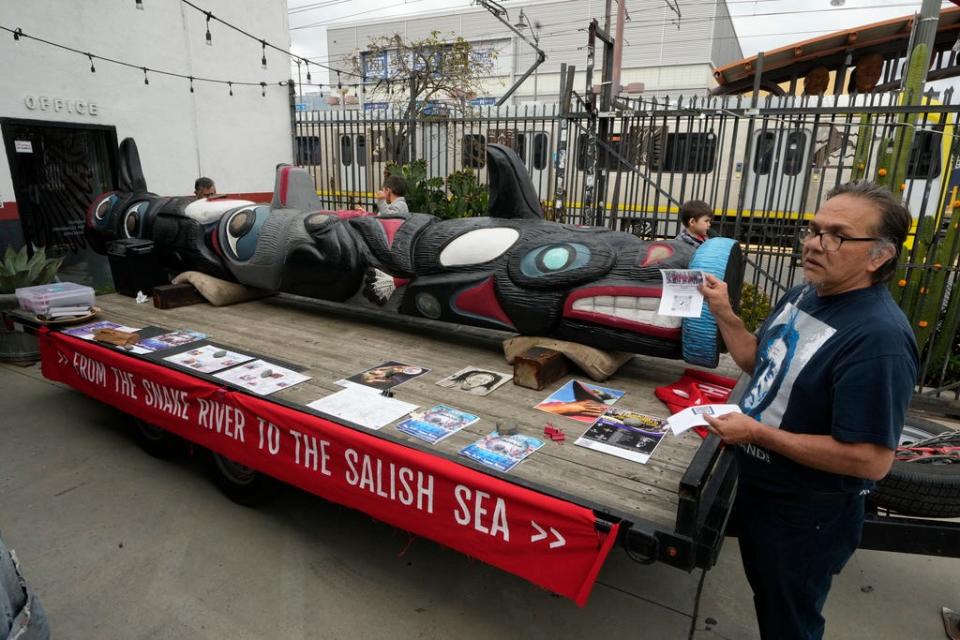 Freddie Lane, a member of the Lummi Nation who traveled from Washington State, with a totem pole touring across the country to stop the degradation of Native lands, joins members of the Apache Stronghold group gathered in the Los Angeles neighborhood of Boyle Heights at Self Help Graphics & Art paint protest signs on Monday, March 20, 2023. The Apache group battling a foreign mining firm that wants to build one of the largest copper mines in the United States on what tribal members say is sacred land will get a new chance to make its point Tuesday when a full federal appeals court panel takes another look at the case.