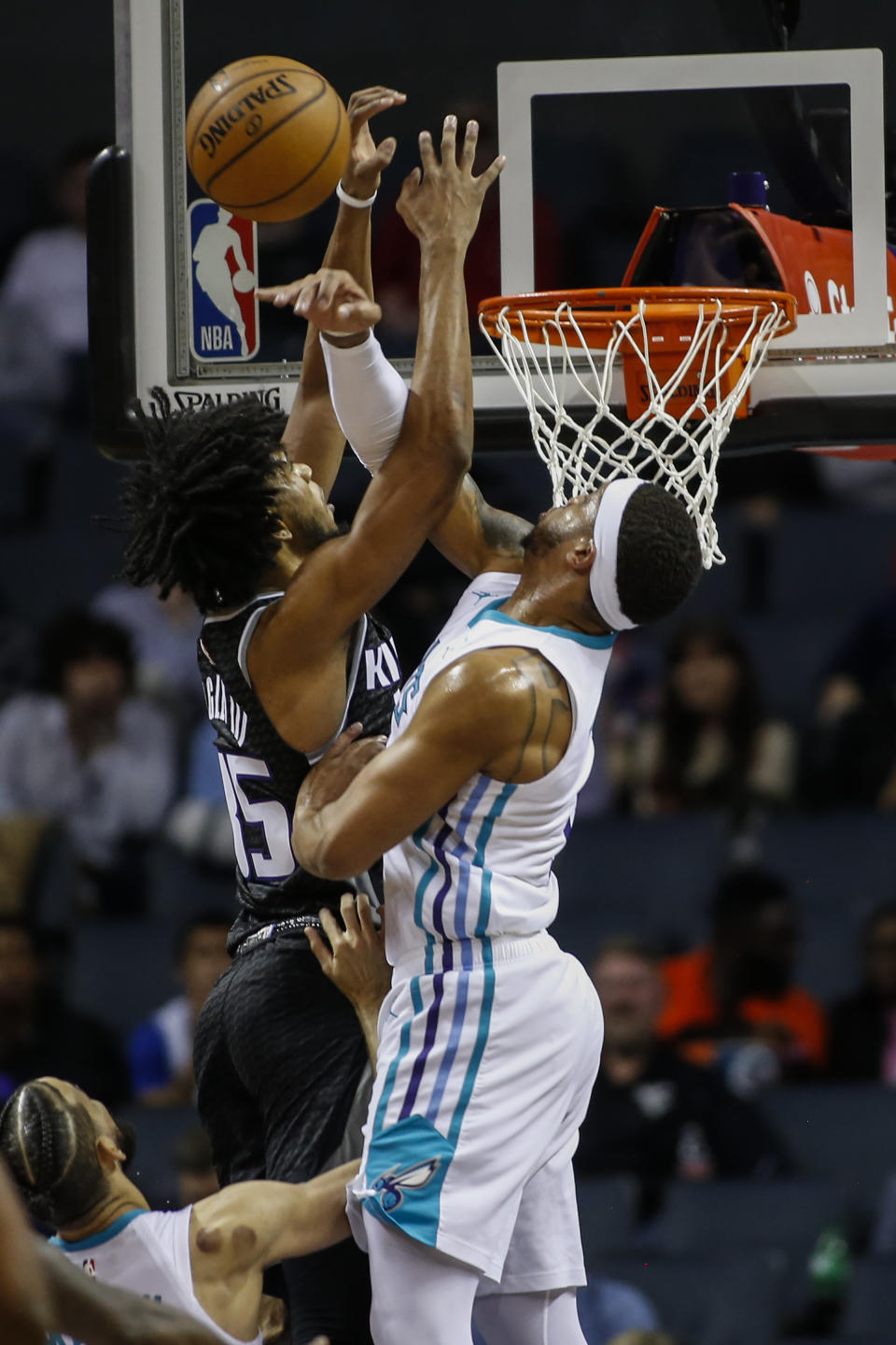 Charlotte Hornets forward Miles Bridges, right, blocks the shot of Sacramento Kings forward Marvin Bagley III in the first half of an NBA basketball game in Charlotte, N.C., Tuesday, Dec. 17, 2019. (AP Photo/Nell Redmond)