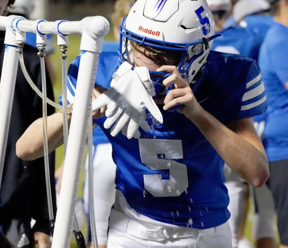 Valley Christian's Gunnar Link 5, hydrates during their game against Snowflake Aug, 27, 2021 at Valley Christian High School in Chandler. 