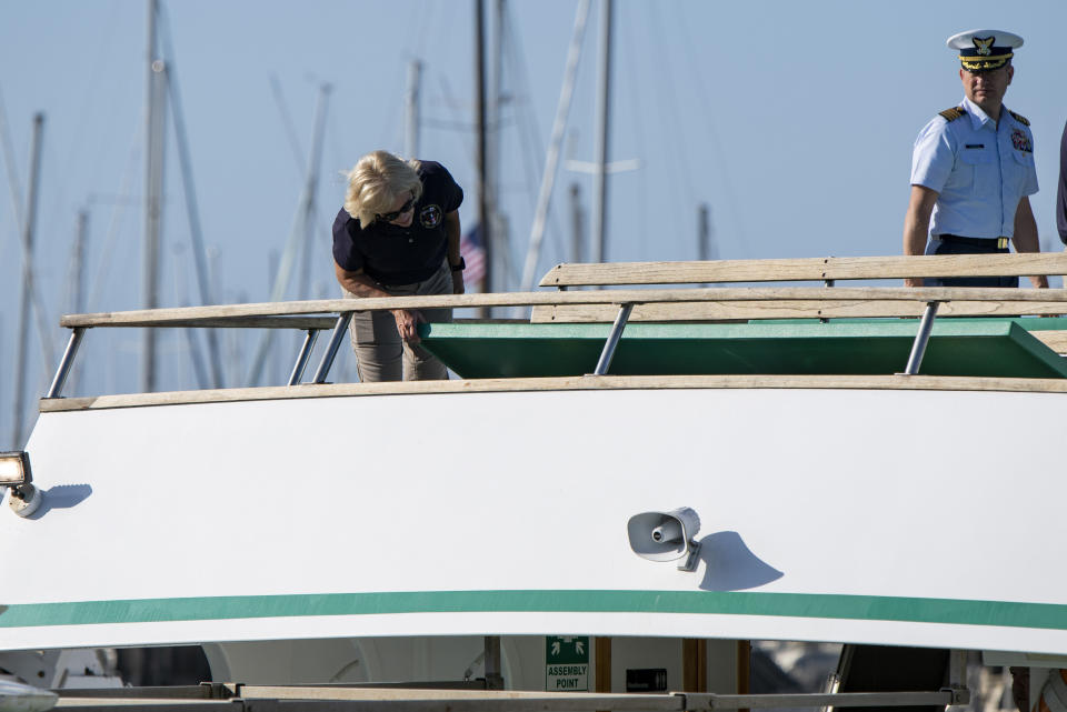 National Transportation Safety Board Board member Jennifer Homendy, left, and Jason Neubauer of the U.S. Coast Guard inspect the Vision, a sister vessel to the dive boat Conception at Santa Barbara Harbor on Wednesday, Sept. 4, 2019 in Santa Barbara, Calif. A fire raged through a boat carrying recreational scuba divers anchored near an island off the Southern California Coast on Monday, Sept. 2, leaving multiple people dead. (AP Photo/Christian Monterrosa )