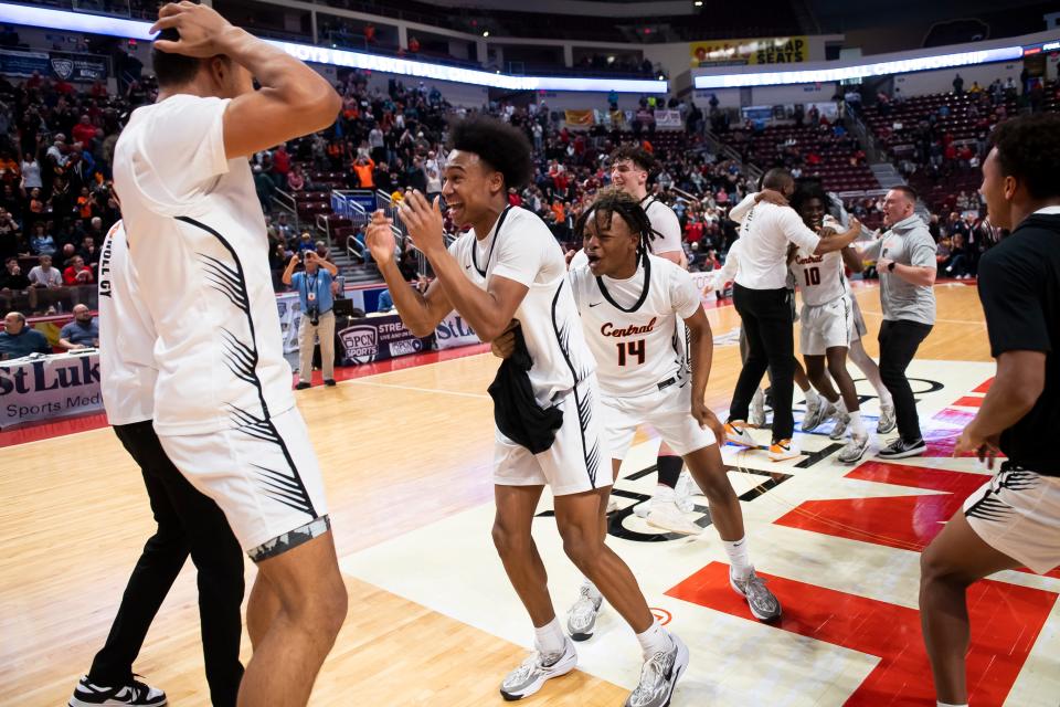Central York players including Saxton Suchanic (middle) celebrate on the court after winning the PIAA Class 6A championship against Parkland. The Panthers won, 53-51, to capture their first title in program history.