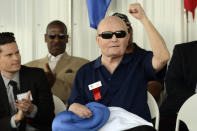 FILE - Boxing referee Mills Lane, pumps his fist while being inducted into the International Boxing Hall of Fame during the annual induction ceremony in Canastota, N.Y., June 9, 2013. Lane, the Hall of Fame boxing referee who was the third man in the ring when Tyson bit Holyfield’s ear, died Tuesday, Dec. 6, 2022. He was 85. Lane had suffered a stroke in 2002 and son Tommy said his father had taken a significant turn for the worse recently before entering hospice care on Friday. (AP Photo/Heather Ainsworth, File)