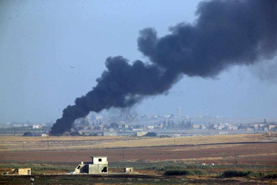 In this photo taken from the Turkish side of the border between Turkey and Syria, in Akcakale, Sanliurfa province, southeastern Turkey, smoke billows from a fire inside Syria during bombardment by Turkish forces, Oct. 9, 2019. (Photo: Lefteris Pitarakis/AP)