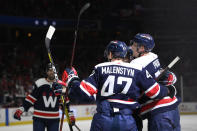 Washington Capitals center Aliaksei Protas, right, celebrates his goal with left wing Beck Malenstyn (47) and others during the first period of an NHL hockey game against the Columbus Blue Jackets, Saturday, Dec. 4, 2021, in Washington. (AP Photo/Nick Wass)