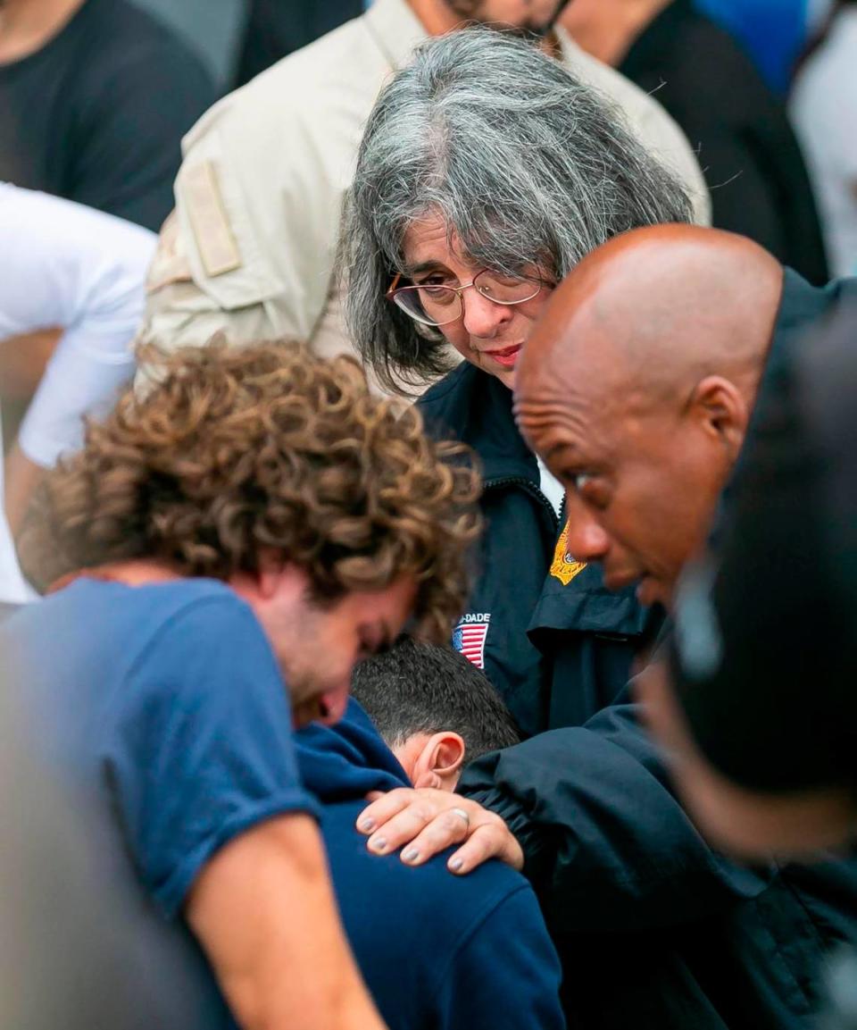 Miami-Dade County Mayor Daniella Levine Cava and County Commissioner Oliver G. Gilbert console people waiting for updates from the Champlain Towers collapse site at a reunification center at 9301 Collins Ave. in Surfside on Thursday, June 24, 2021. 