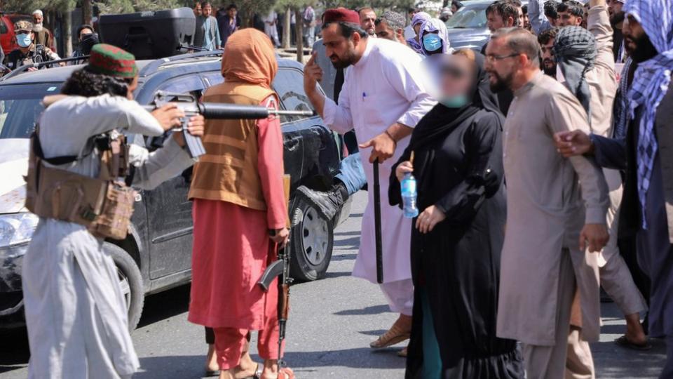 Un talibán apunta a uno de los manifestantes.