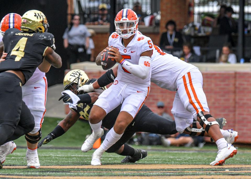 Clemson quarterback D.J. Uiagalelei (5) runs near Wake Forest defensive end Jacorey Johns during the fourth quarter at Truist Field in Winston-Salem, North Carolina Saturday, September 24, 2022.  