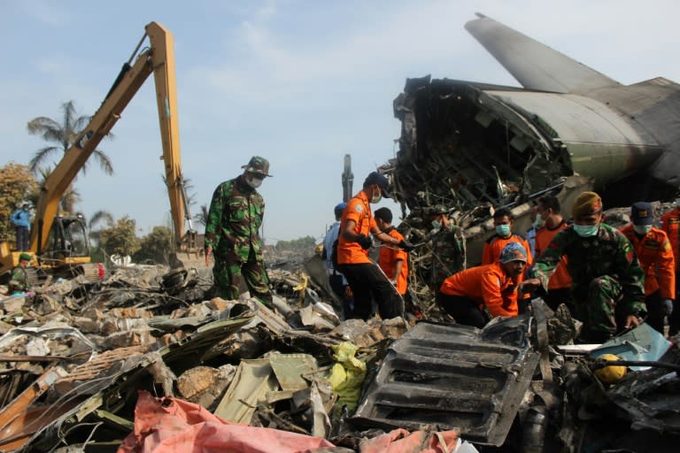 Soldiers search the wreckage of an Indonesian Air Force C-130 Hercules aircraft a day after it crashed in a residential area of Medan, in northern Sumatra province on July 1, 2015