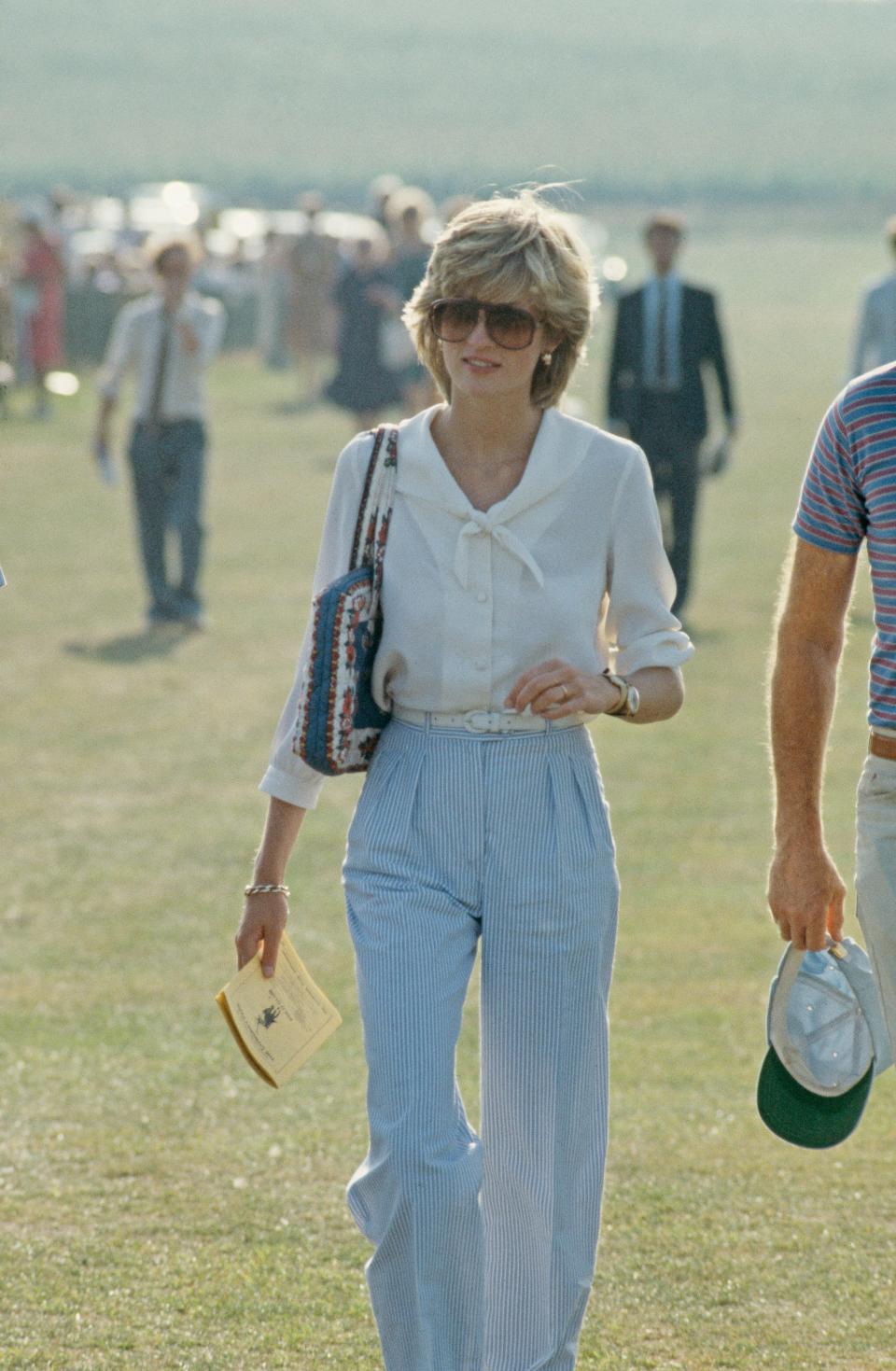 princess diana wearing a white shirt and blue pants to a polo match