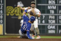 Houston Astros second baseman Jose Altuve, top, attempts a double play over Texas Rangers' Isiah Kiner-Falefa during the eighth inning of a baseball game, Saturday, May 15, 2021, in Houston. Rangers' Andy Ibanez was safe at first. (AP Photo/Eric Christian Smith)