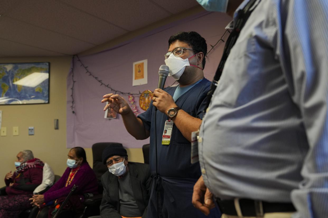 Dr. Subhankar Chakraborty, a gastroenterologist at Ohio State University's Wexner Medical Center, answers a question during a session with elderly Bhutanese people at Himalayan Day Care. The health professionals are part of an organization focusing on cancer awareness for new Americans.