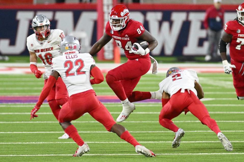 Fresno State tight end Tre Watson, center, tries to hop between New Mexico defenders during a 25-17 loss to to the Lobos at Valley Children’s Stadium on Saturday, Nov. 18, 2023.