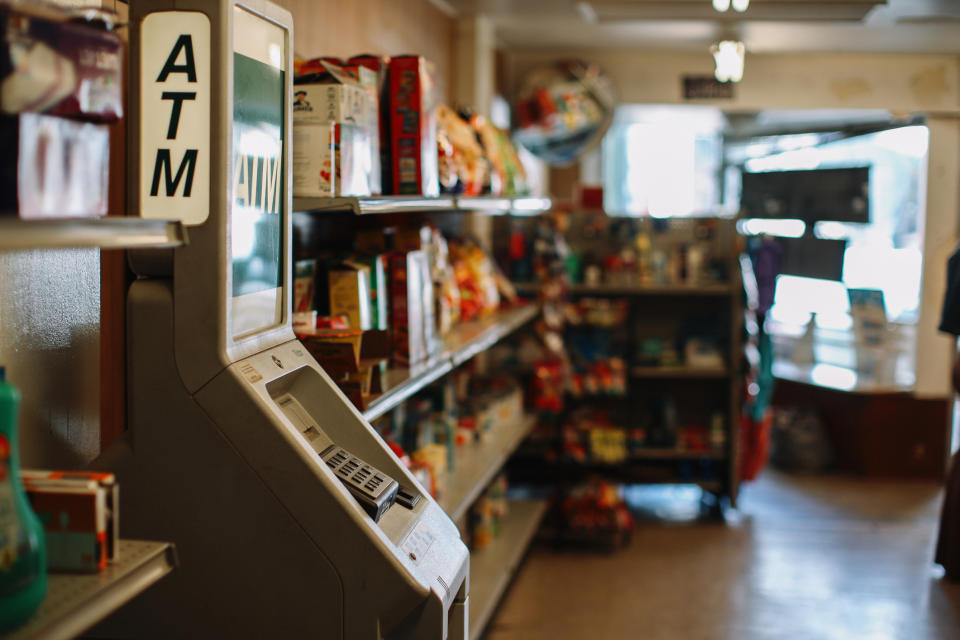 ATM in a convenience store with snacks and drinks in the background