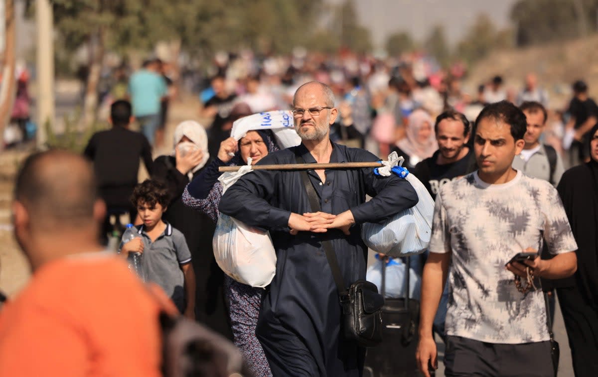 Palestinians families fleeing Gaza City and other parts of northern Gaza towards the southern areas, walk along a highway on November 9, 2023 (AFP via Getty Images)