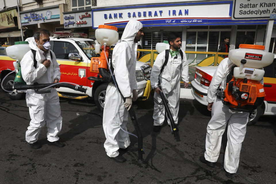 Firefighters prepare to disinfect a street against the new coronavirus, in western Tehran, Iran, Friday, March 13, 2020. The new coronavirus outbreak has reached Iran's top officials, with its senior vice president, Cabinet ministers, members of parliament, Revolutionary Guard members and Health Ministry officials among those infected. The vast majority of people recover from the new coronavirus. According to the World Health Organization, most people recover in about two to six weeks, depending on the severity of the illness. (AP Photo/Vahid Salemi)