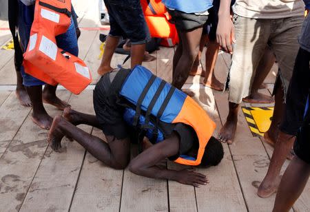 A migrant prays on his knees after boarding the Migrant Offshore Aid Station (MOAS) rescue ship Topaz Responder around 20 nautical miles off the coast of Libya, June 23, 2016. Picture taken June 23, 2016. REUTERS/Darrin Zammit Lupi
