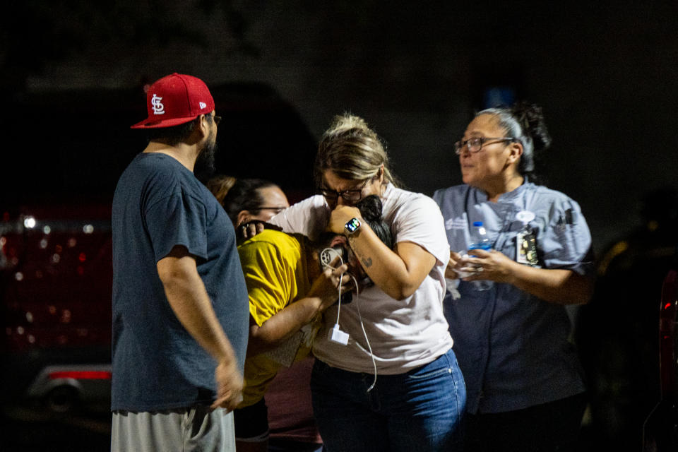 UVALDE, TEXAS - MAY 24: A family grieves outside of the SSGT Willie de Leon Civic Center following the mass shooting at Robb Elementary School on May 24, 2022 in Uvalde, Texas. According to reports, 19 students and 2 adults were killed, with the gunman fatally shot by law enforcement. (Photo by Brandon Bell/Getty Images)