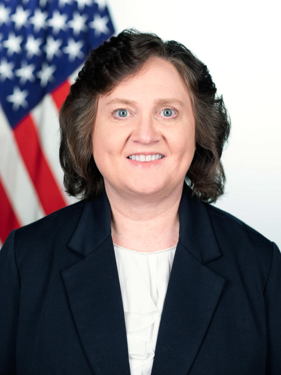 This photo provided by The White House shows Lynne Parker. The computer scientist made breakthroughs in getting robots to work together so they could perform difficult missions, like cleaning up after a nuclear disaster, waxing floors or pulling barnacles off a ship. Her job now is getting the U.S. government working together — alongside American businesses, research universities and international allies — as director of a new national initiative on artificial intelligence. (Keegan Barber/The White House via AP)