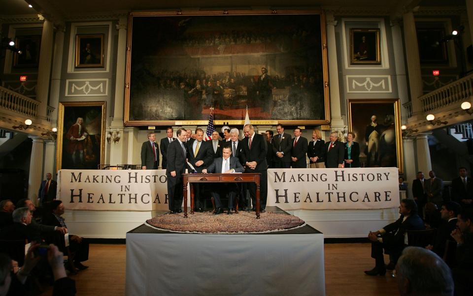 Mitt Romney's most lasting policy accomplishment was the quasi-universal health care he signed as governor of Massachusetts. At the 2006 signing ceremony, he was happy to show off the partnership that made it possible, even though the partner was liberal Democratic Sen. Ted Kennedy.  (Photo: Joe Raedle/Getty Images)