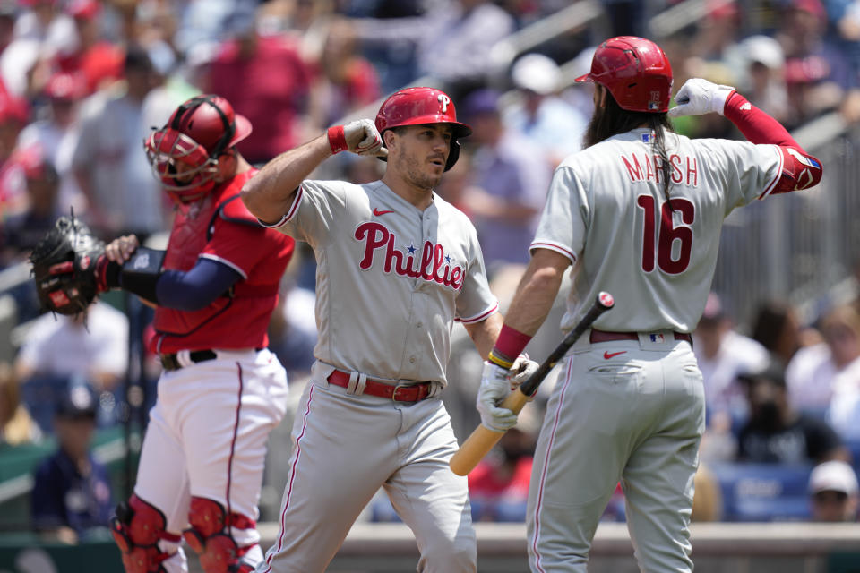 Philadelphia Phillies' J.T. Realmuto, center, celebrates his solo home run with teammate Brandon Marsh in the second inning of a baseball game against the Washington Nationals, Sunday, June 4, 2023, in Washington. (AP Photo/Patrick Semansky)