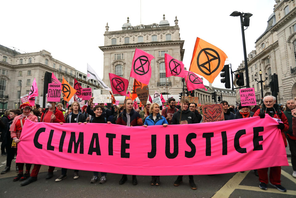 Protesters during an Extinction Rebellion (XR) march through Piccadilly Circus to Parliament Square in London.