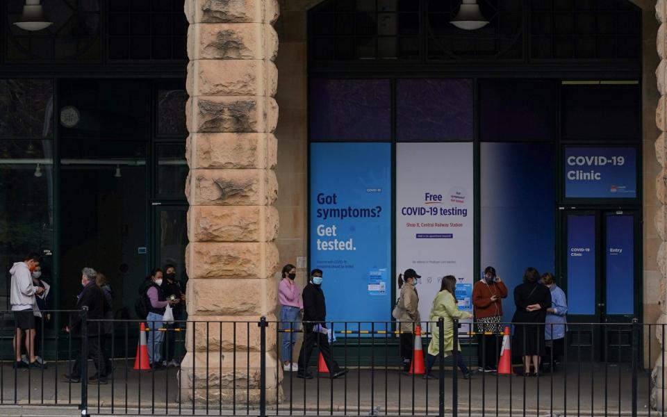 People wait in line outside a Covid-19 testing centre in Sydney - Loren Elliott/Reuters