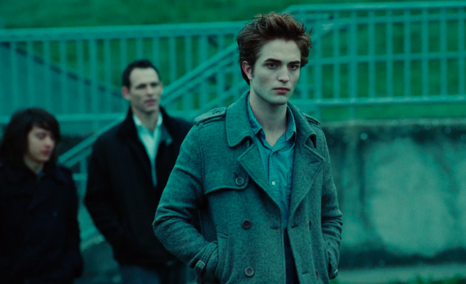 Edward wearing jeans, a button-up, and a peacoat