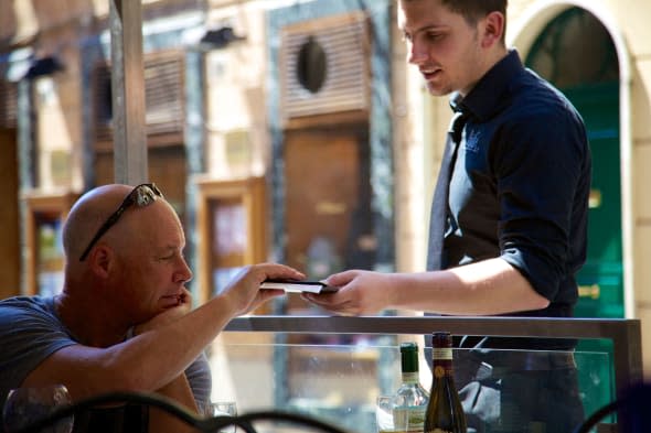 paying bill at cafe Rome Italy