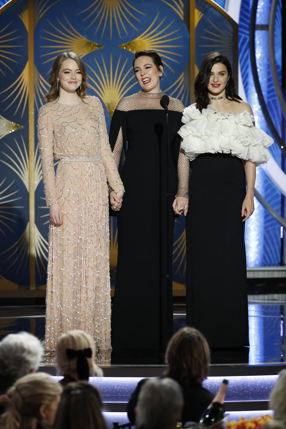 Emma Stone, Olivia Colman, and Rachel Weisz speak onstage during the 76th Annual Golden Globe Awards.