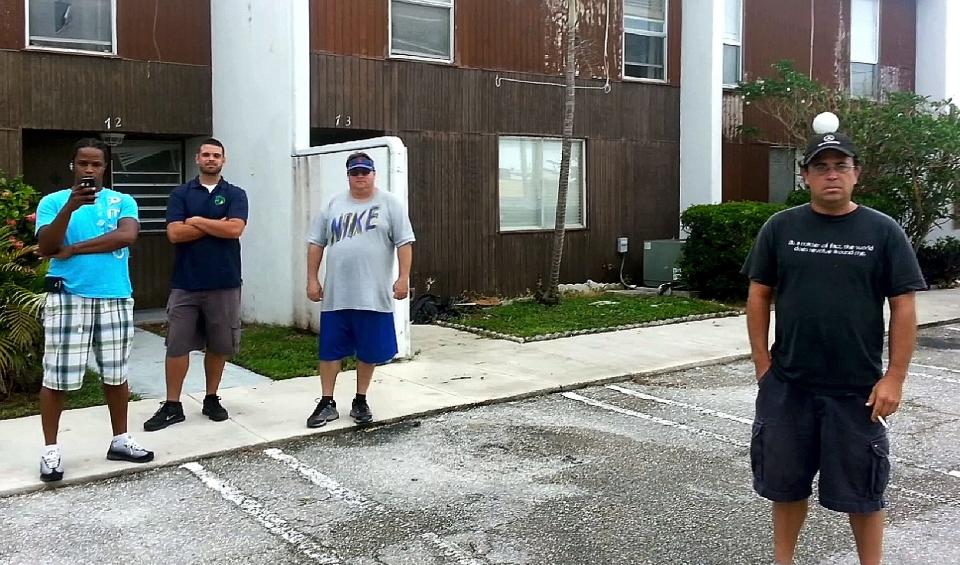 In this undated image from video, Ken Bailynson, foreground right, stands in the parking lot at Green Terrace Condominiums. (Photo provided)