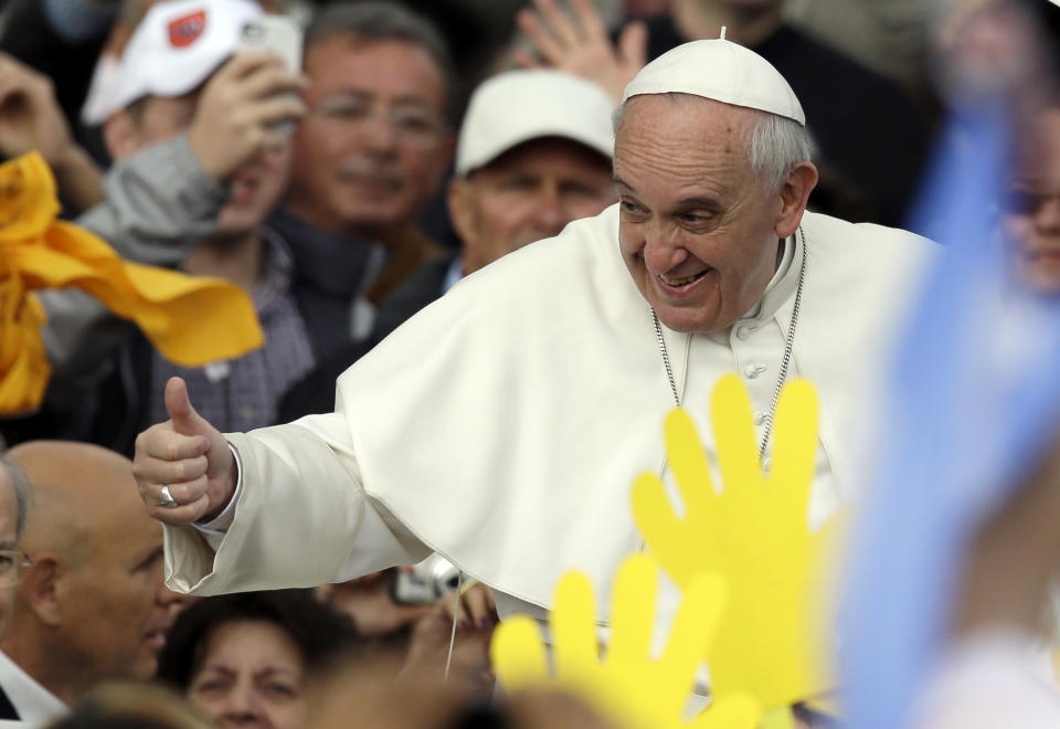 Pope Francis gives his thumbs up as he arrives for his general audience in St. Peter's square at the Vatican, Wednesday, April 9, 2014. (AP Photo/Gregorio Borgia)