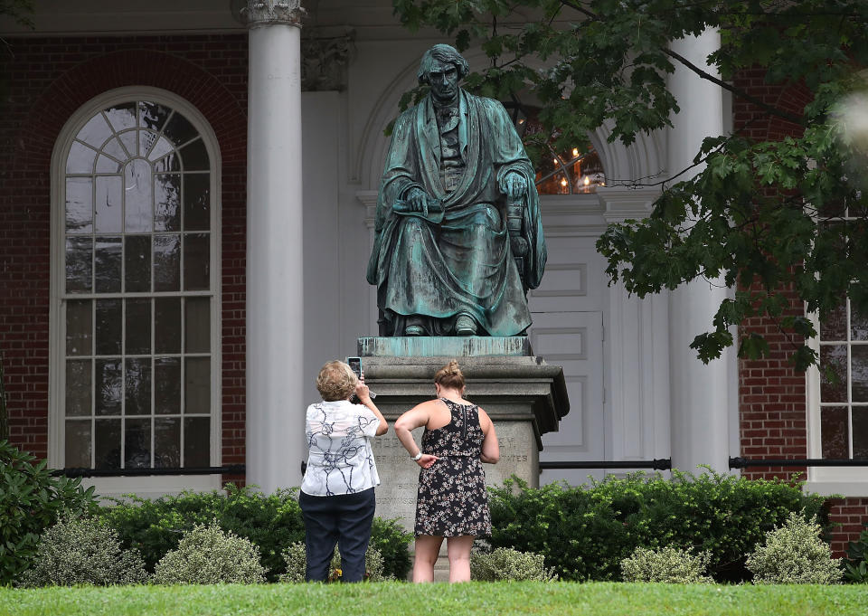 <p>Two women take pictures in front of the statue of US Supreme Court Chief Justice Roger Brooke Taney that sits in front of the Maryland State House, on August 16, 2017 in Annapolis, Md. Maryland Governor Larry Hogan has called for the removal of the statue. Taney was the author of the Dred Scott decision. (Photo: Mark Wilson/Getty Images) </p>