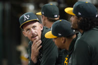 Oakland Athletics pitchers Chris Bassitt, from left, sits with Frankie Montas and Sean Manaea during the fourth inning of a baseball game against the Seattle Mariners in Oakland, Calif., Wednesday, Sept. 22, 2021. (AP Photo/Jeff Chiu)