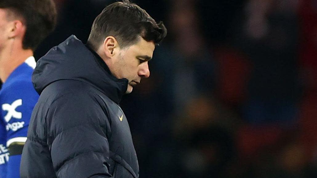 Mauricio Pochettino walks in a dejected manner