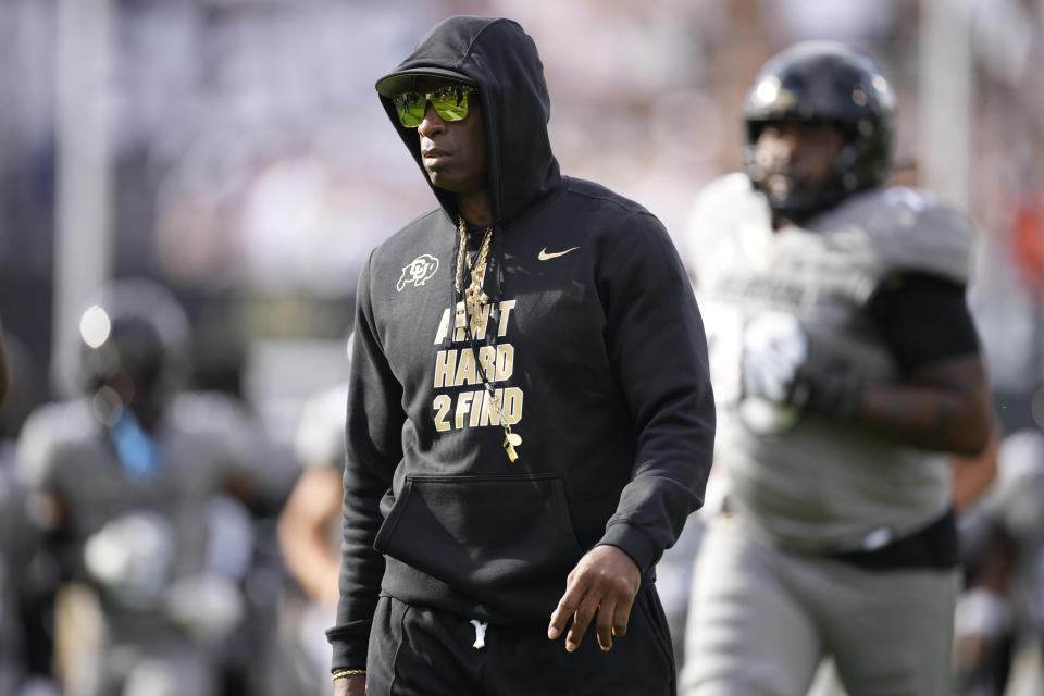 Colorado head coach Deion Sanders looks on as players warm up before an NCAA college football game against USC Saturday, Sept. 30, 2023, in Boulder, Colo. Deion Sanders is accomplishing what he pledged to do by overhauling his offensive line to better protect his often-hit quarterback son. The Colorado coach reached into the transfer portal and brought in linemen from the University of Houston, Connecticut, Indiana and UTEP. (AP Photo/David Zalubowski)