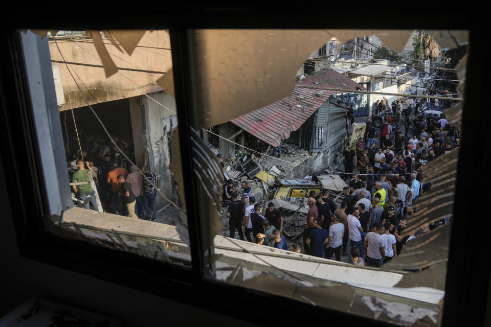 Palestinians inspect a damaged building following an Israeli army raid, in Nour Shams refugee camp in the northern West Bank, Tuesday, Sept. 5, 2023. Palestinian Ministry of Health says one Palestinian man was killed in the West Bank refugee camp. (AP Photo/Majdi Mohammed)