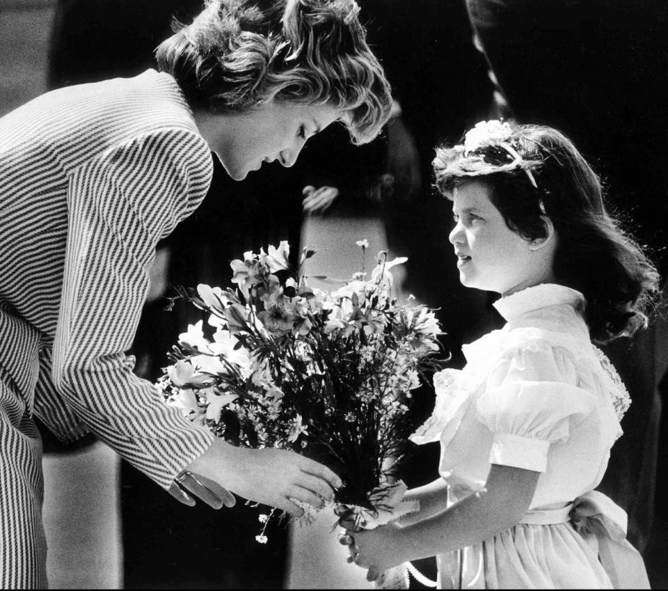 Princess Diana accepts flowers from Tara Sansbury, 7, of West Palm Beach, on Nov. 11, 1985. She came to town to watch then-husband Prince Charles play polo in Wellington.