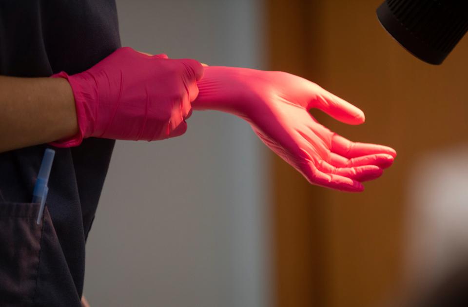 A doctor at the Women's Med Center in Kettering, near Dayton, Ohio, puts gloves on to prepare for an abortion, Thursday, June 30, 2022. When Roe vs. Wade was overturned a week ago by the Supreme Court, Kentucky shut down all abortions because of trigger laws. Romanos identified the amniotic sac and said the pregnancy wasn't viable. At a little over six weeks, there was no heart beat.