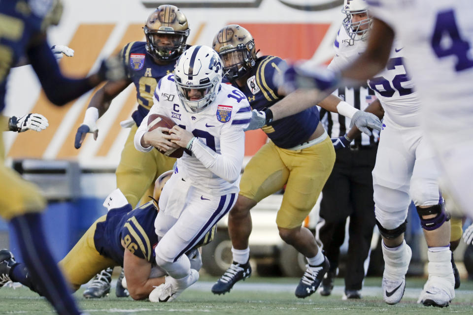 Kansas State quarterback Skylar Thompson (10) is sacked by Navy defensive end Jackson Perkins (96) for a 4-yard loss in the first half of the Liberty Bowl NCAA college football game Tuesday, Dec. 31, 2019, in Memphis, Tenn. (AP Photo/Mark Humphrey)