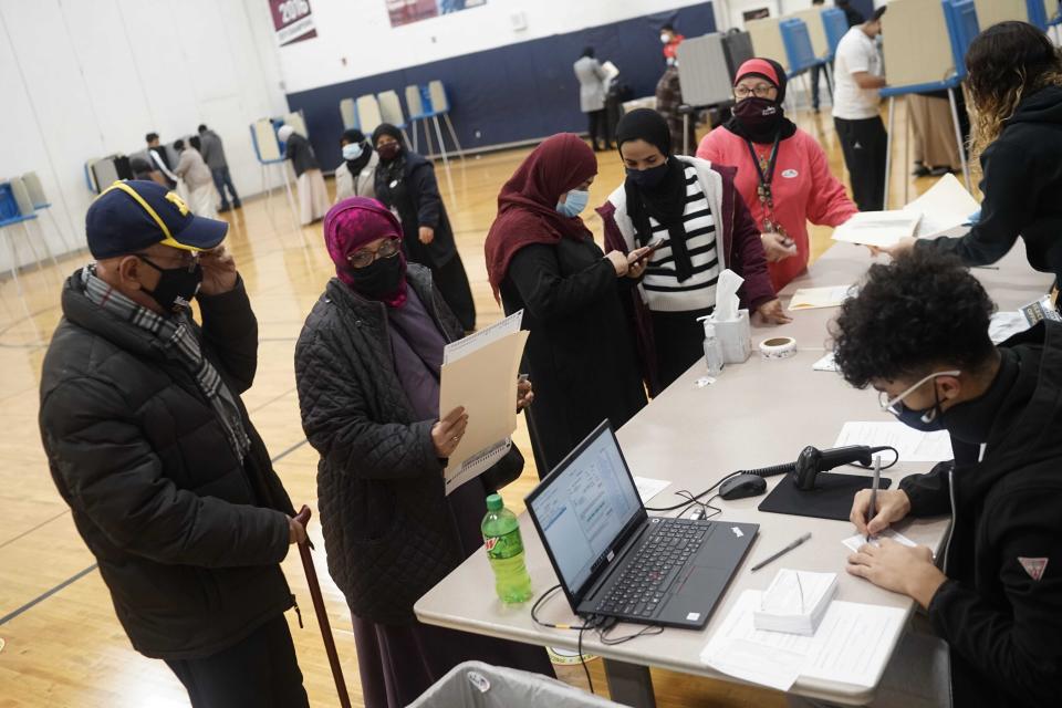 Dawleh Ahmed (second from left) and Naji Ahmed (left) wait in line to vote at Salina Elementary School on Nov. 3 in Dearborn, Michigan. (Photo: Antranik Tavitian/Detroit Free Press/Imagn Content Services, LLC)