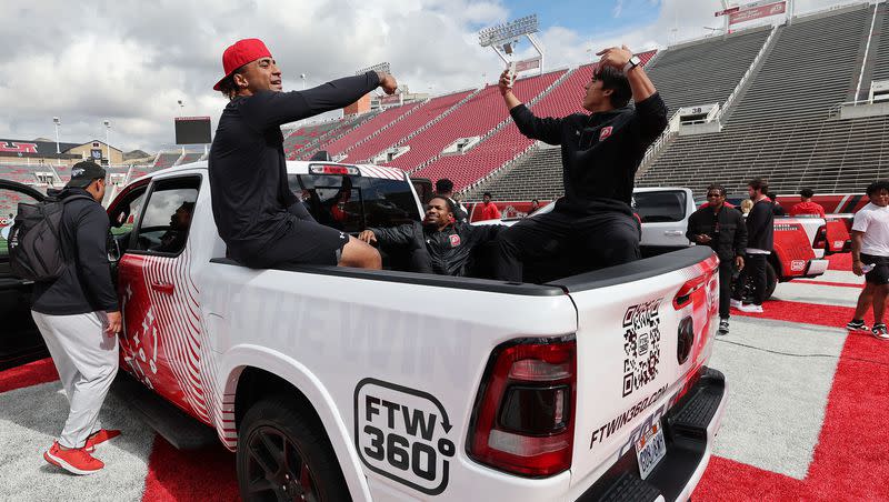 Utah Utes scholarship football players celebrate getting a Dodge truck given to them by the Crimson Collective during an NIL announcement at Rice-Eccles Stadium in Salt Lake City on Wednesday, Oct. 4, 2023.