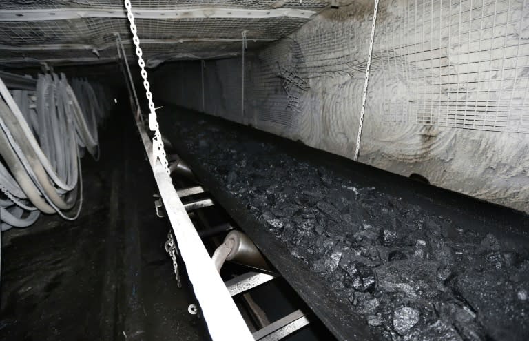 A conveyor belt transports tons of coal at a mine (GEORGE FREY)