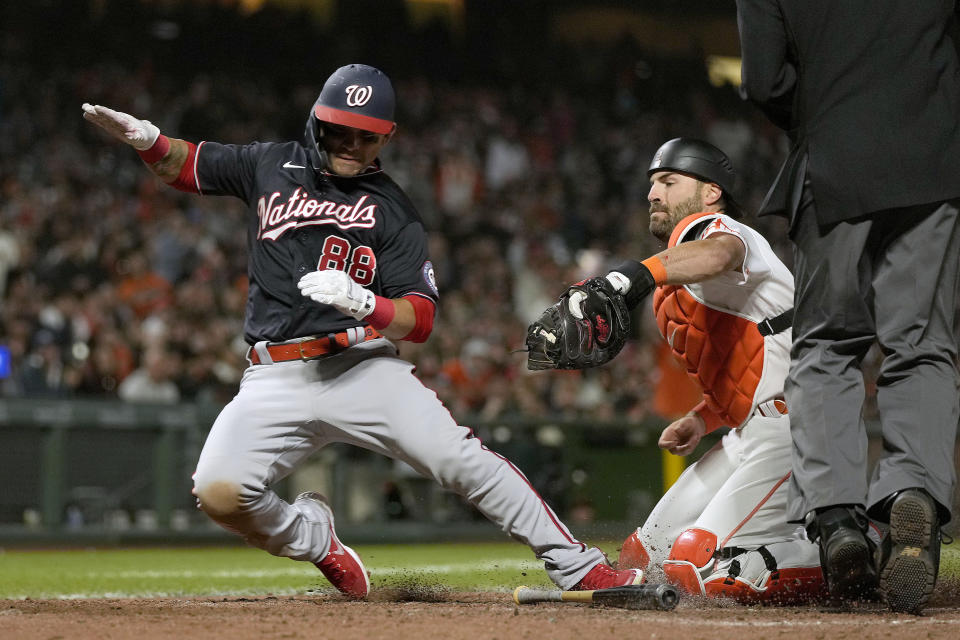 Washington Nationals' Gerardo Parra (88) is tagged out by San Francisco Giants catcher Curt Casali, right, at home plate during the seventh inning of a baseball game Friday, July 9, 2021, in San Francisco. (AP Photo/Tony Avelar)